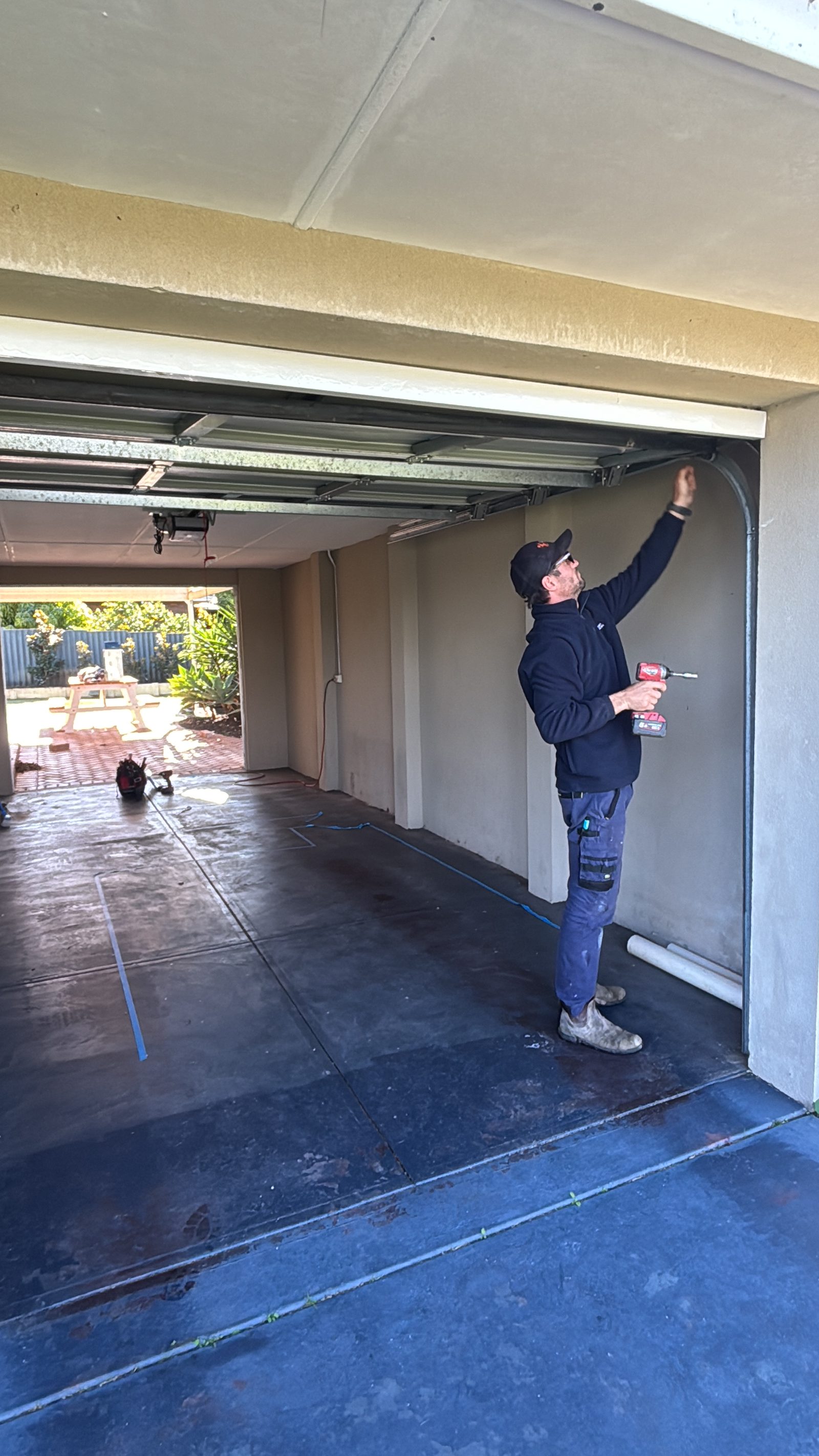 Electrician performing garage wiring installation